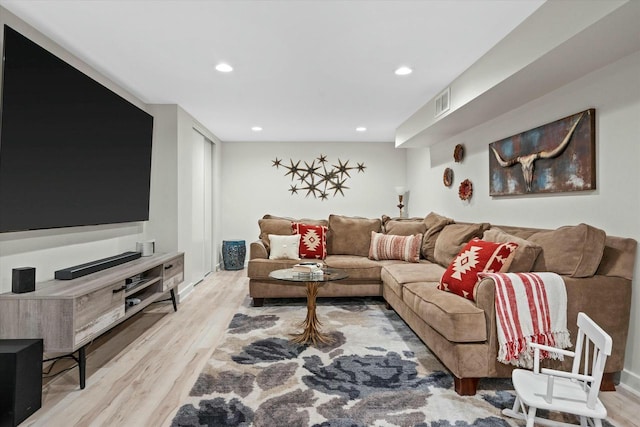 living area with recessed lighting, visible vents, and light wood-type flooring