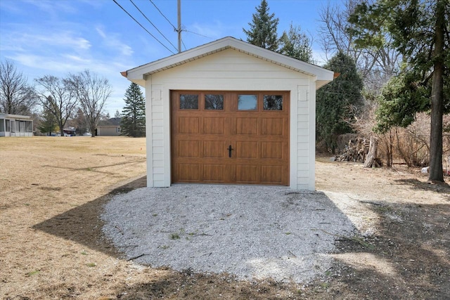 detached garage featuring driveway