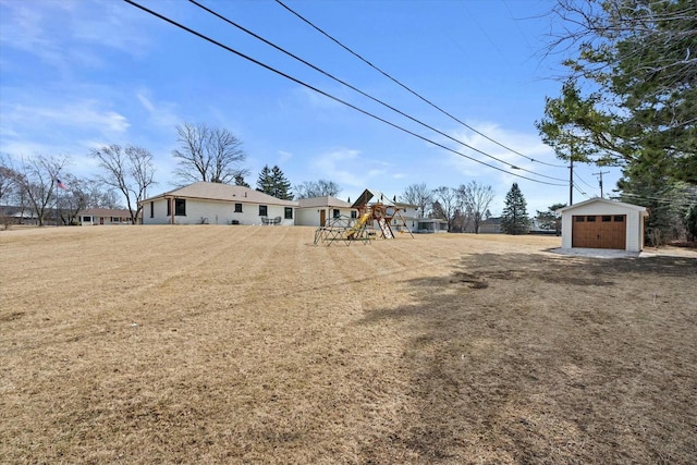 view of yard featuring an outdoor structure and a playground