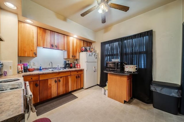 kitchen with white appliances, brown cabinetry, a ceiling fan, light floors, and a sink