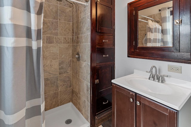 full bath with a stall shower and vanity