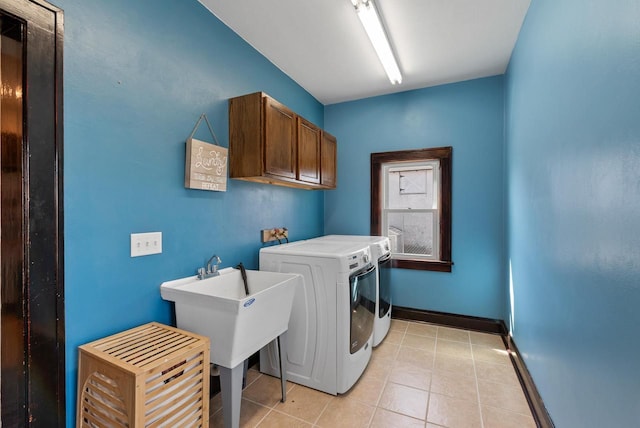 laundry room featuring light tile patterned flooring, cabinet space, baseboards, and separate washer and dryer