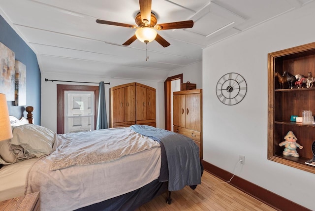 bedroom with baseboards, ceiling fan, attic access, vaulted ceiling, and light wood-style floors