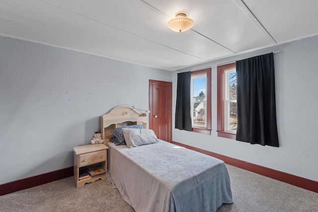 carpeted bedroom featuring baseboards