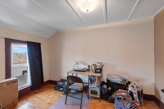 office with baseboards, lofted ceiling, and hardwood / wood-style flooring