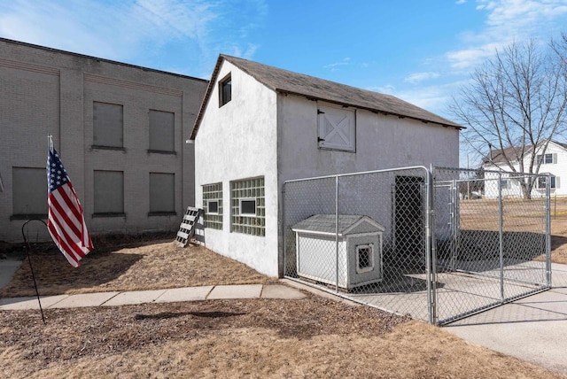 view of outdoor structure with a gate and fence