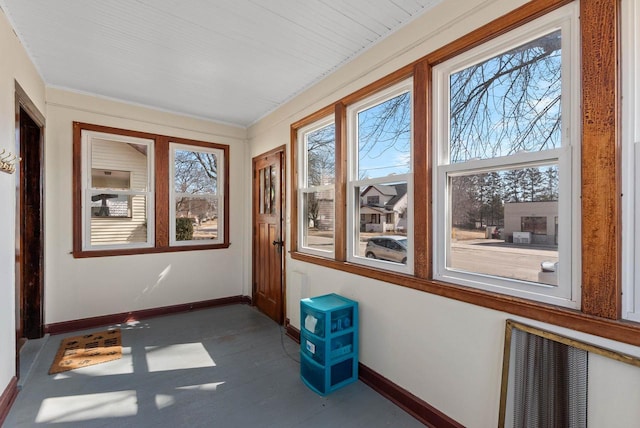 unfurnished sunroom featuring plenty of natural light