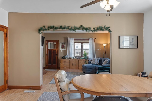 dining area with visible vents, light wood-style floors, and a ceiling fan