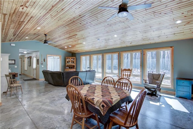 dining room featuring concrete flooring, baseboards, lofted ceiling, and ceiling fan