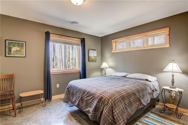 bedroom featuring baseboards, multiple windows, and visible vents