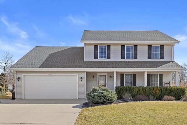 traditional-style house with a porch, concrete driveway, roof with shingles, a front yard, and a garage