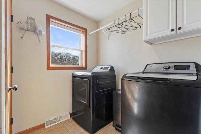 laundry area featuring visible vents, washer and dryer, cabinet space, light tile patterned floors, and baseboards