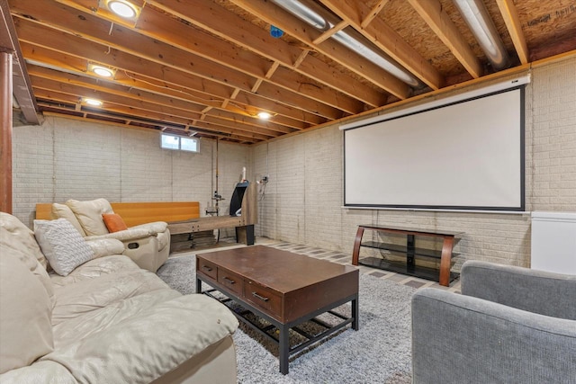 cinema room featuring brick wall