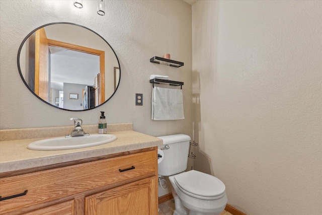 half bath featuring toilet and vanity