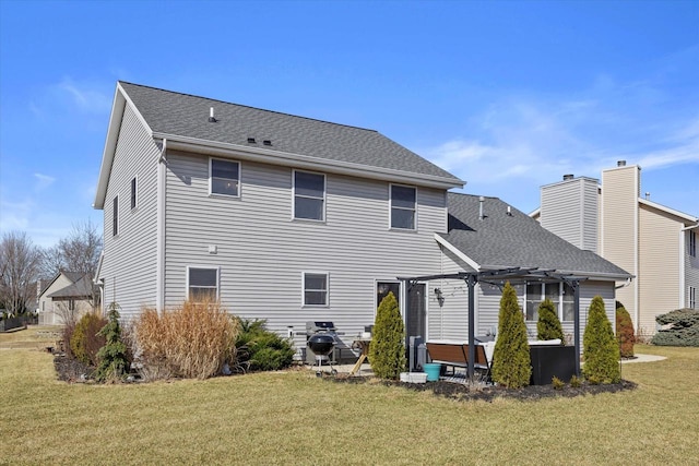 back of property with a lawn, roof with shingles, and a pergola