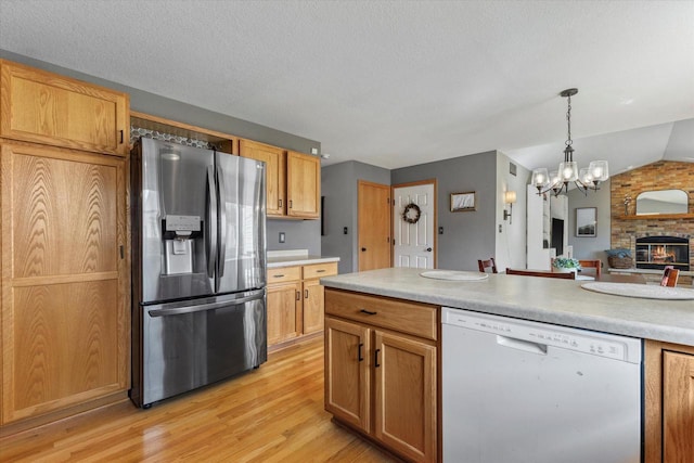 kitchen with a chandelier, light countertops, stainless steel refrigerator with ice dispenser, and white dishwasher