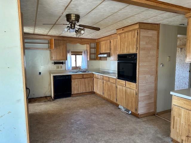 kitchen with black appliances, under cabinet range hood, a sink, light countertops, and ceiling fan