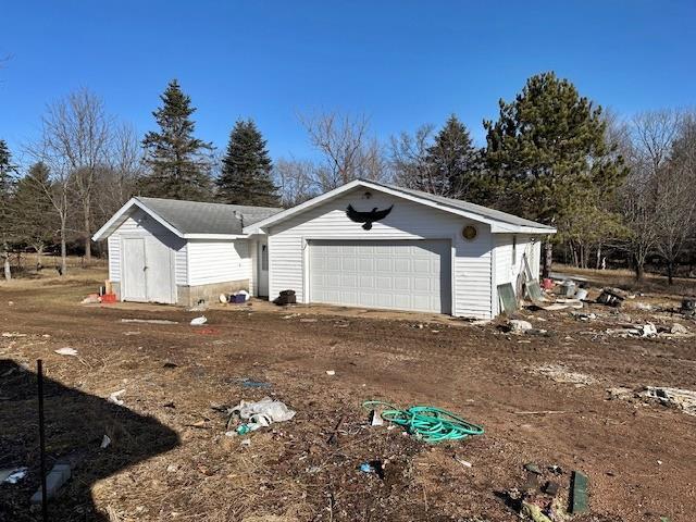 view of property exterior with an outbuilding and an attached garage