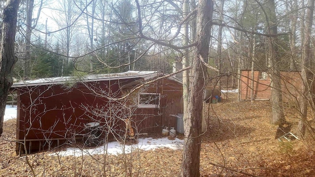 snow covered structure with an outdoor structure