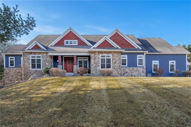 craftsman house featuring stone siding and a front lawn