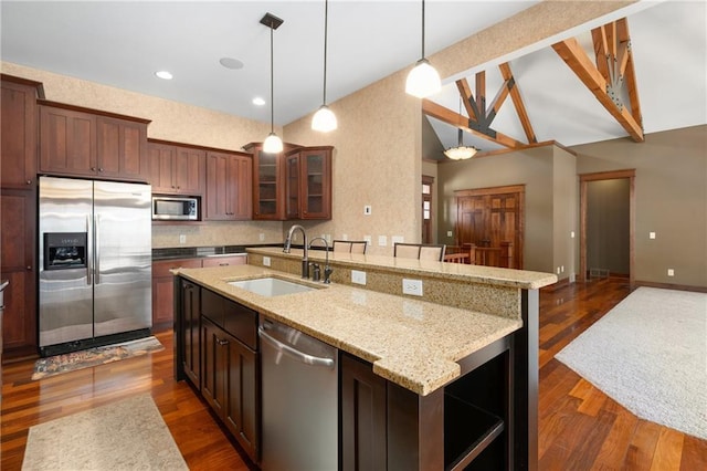 kitchen featuring a sink, dark wood-style floors, stainless steel appliances, glass insert cabinets, and vaulted ceiling with beams