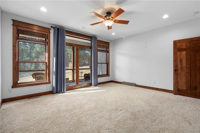 carpeted empty room with visible vents, recessed lighting, baseboards, and ceiling fan