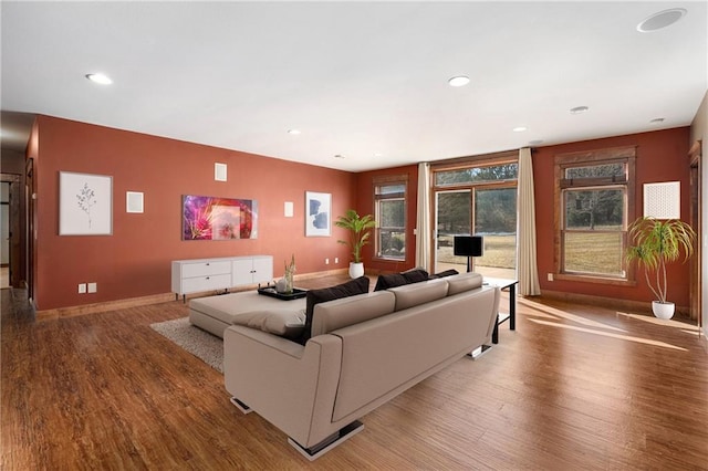 living area with recessed lighting, wood finished floors, and baseboards