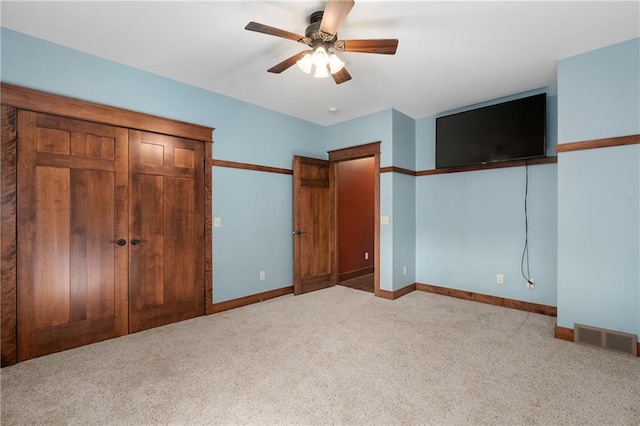 unfurnished bedroom featuring visible vents, ceiling fan, baseboards, and carpet floors