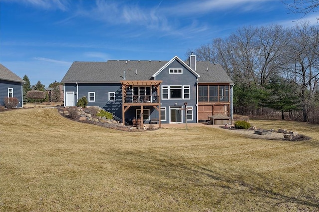 back of house featuring a lawn, a deck, a pergola, a sunroom, and a chimney