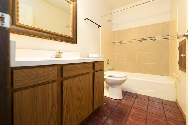 bathroom featuring tile patterned flooring, toilet, vanity, and washtub / shower combination