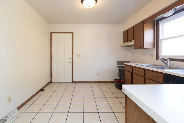 kitchen with visible vents, a sink, light tile patterned flooring, light countertops, and dishwasher