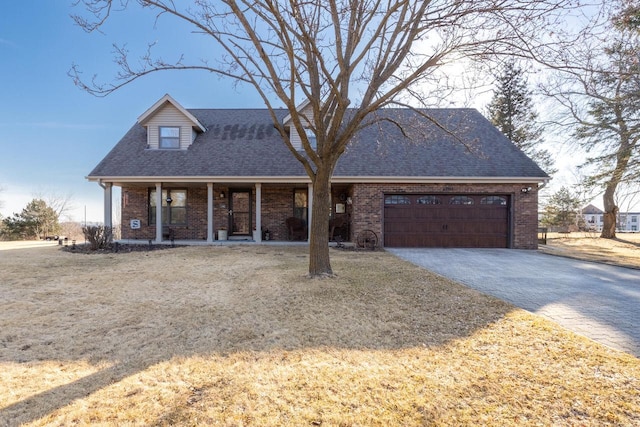 cape cod-style house with a garage, brick siding, roof with shingles, and driveway