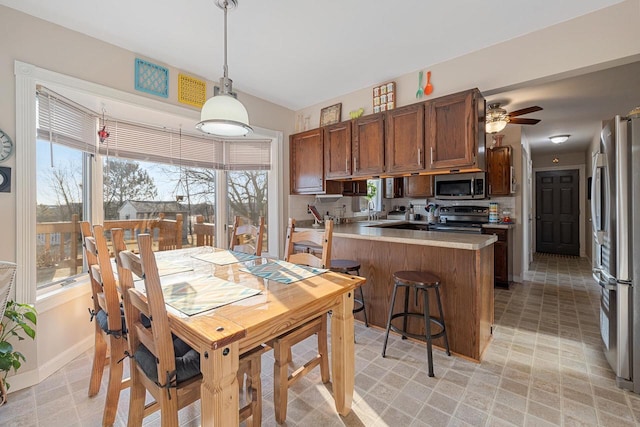 dining area with baseboards and a ceiling fan