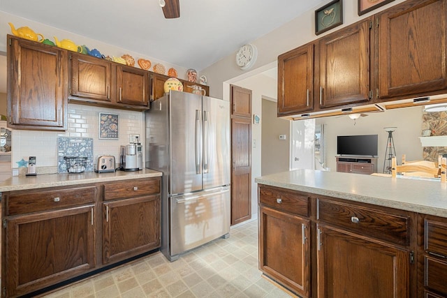 kitchen with light floors, ceiling fan, light countertops, and freestanding refrigerator