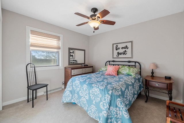 bedroom with baseboards, baseboard heating, ceiling fan, and carpet flooring