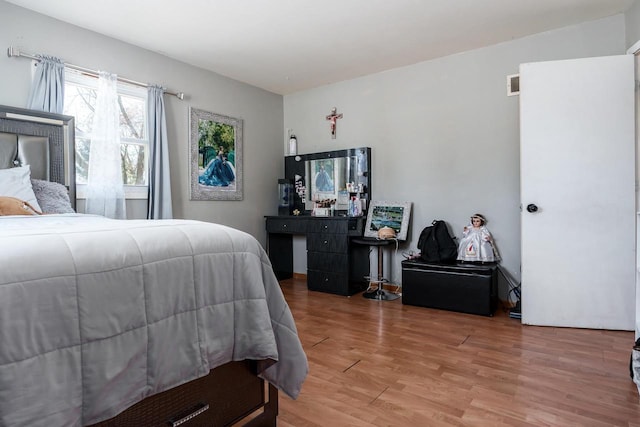 bedroom with visible vents and light wood-style floors