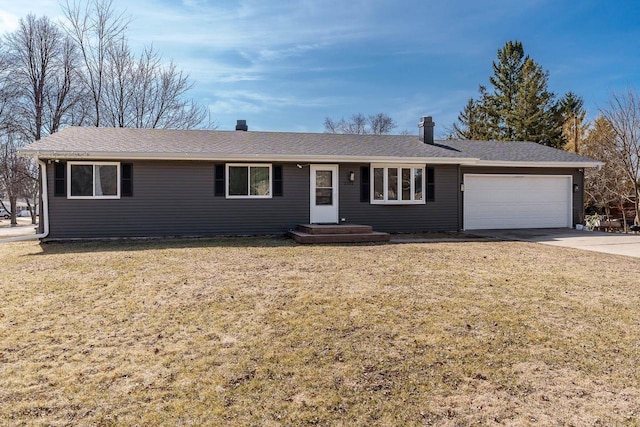 ranch-style home with a front lawn, an attached garage, and driveway