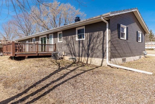 exterior space with crawl space, cooling unit, and a deck