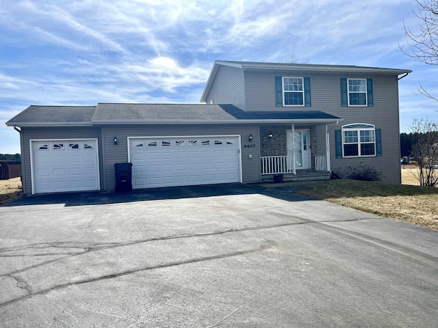 traditional home with aphalt driveway and a garage