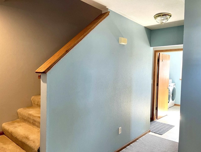 staircase featuring washer / dryer and baseboards