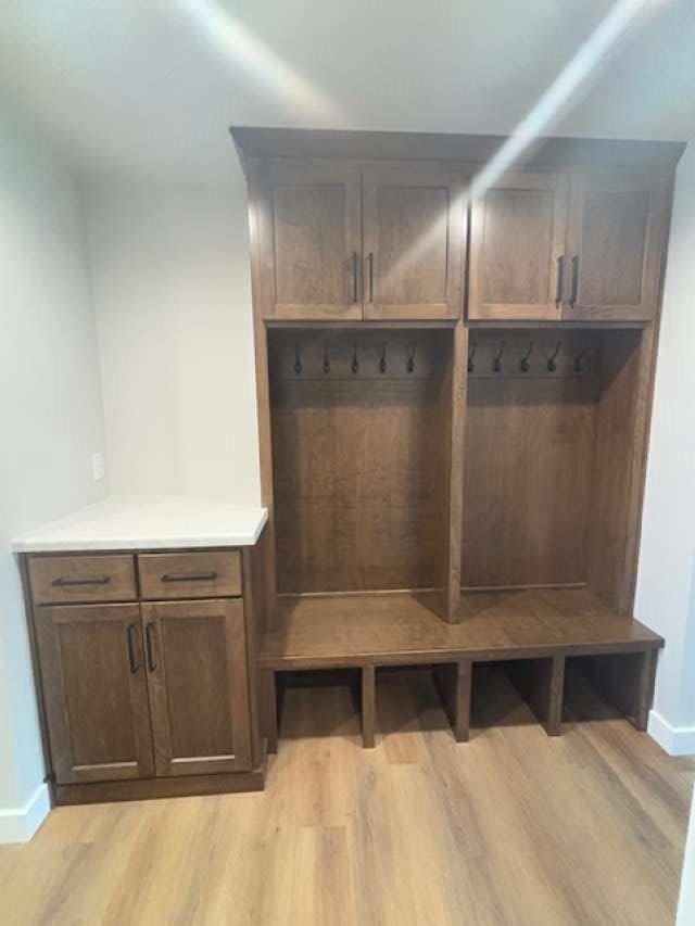 mudroom featuring light wood-type flooring and baseboards