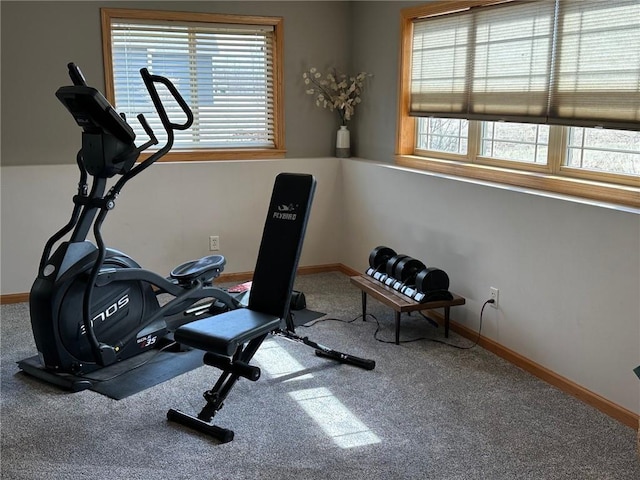 exercise room featuring a healthy amount of sunlight and baseboards