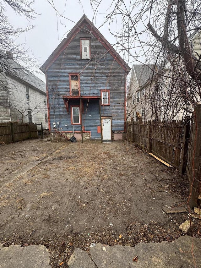 rear view of house with fence