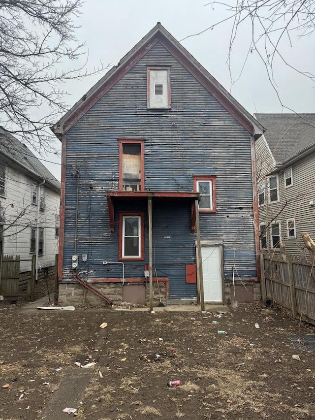 rear view of property with fence