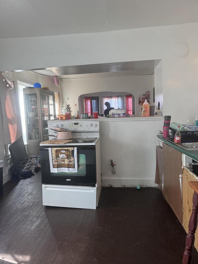 kitchen featuring electric stove and dark wood-type flooring