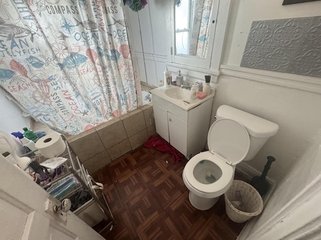 bathroom with vanity, toilet, and tiled shower / bath combo