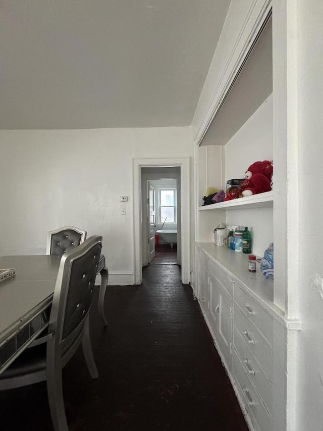 corridor with baseboards and dark wood finished floors