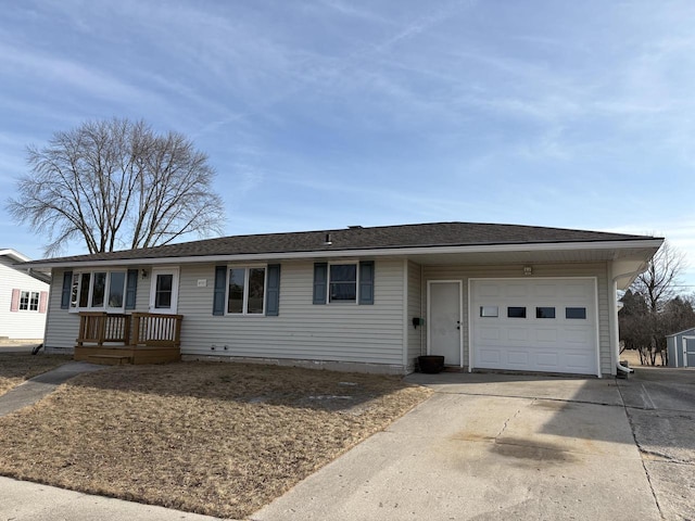 ranch-style house featuring driveway, an attached garage, and a shingled roof