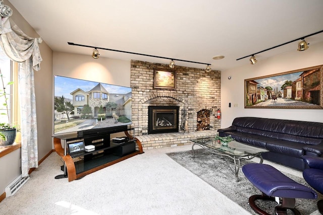 carpeted living room with visible vents, a brick fireplace, and rail lighting