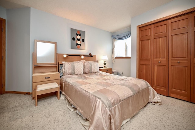 bedroom featuring a closet, baseboards, and carpet floors